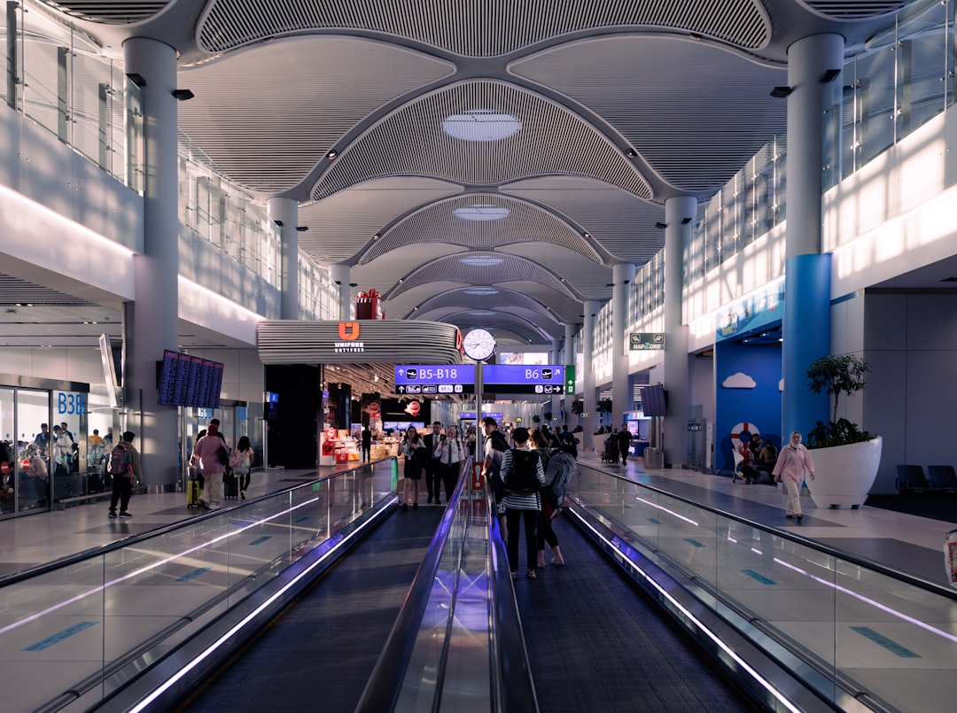 A group of people walking through an airport,