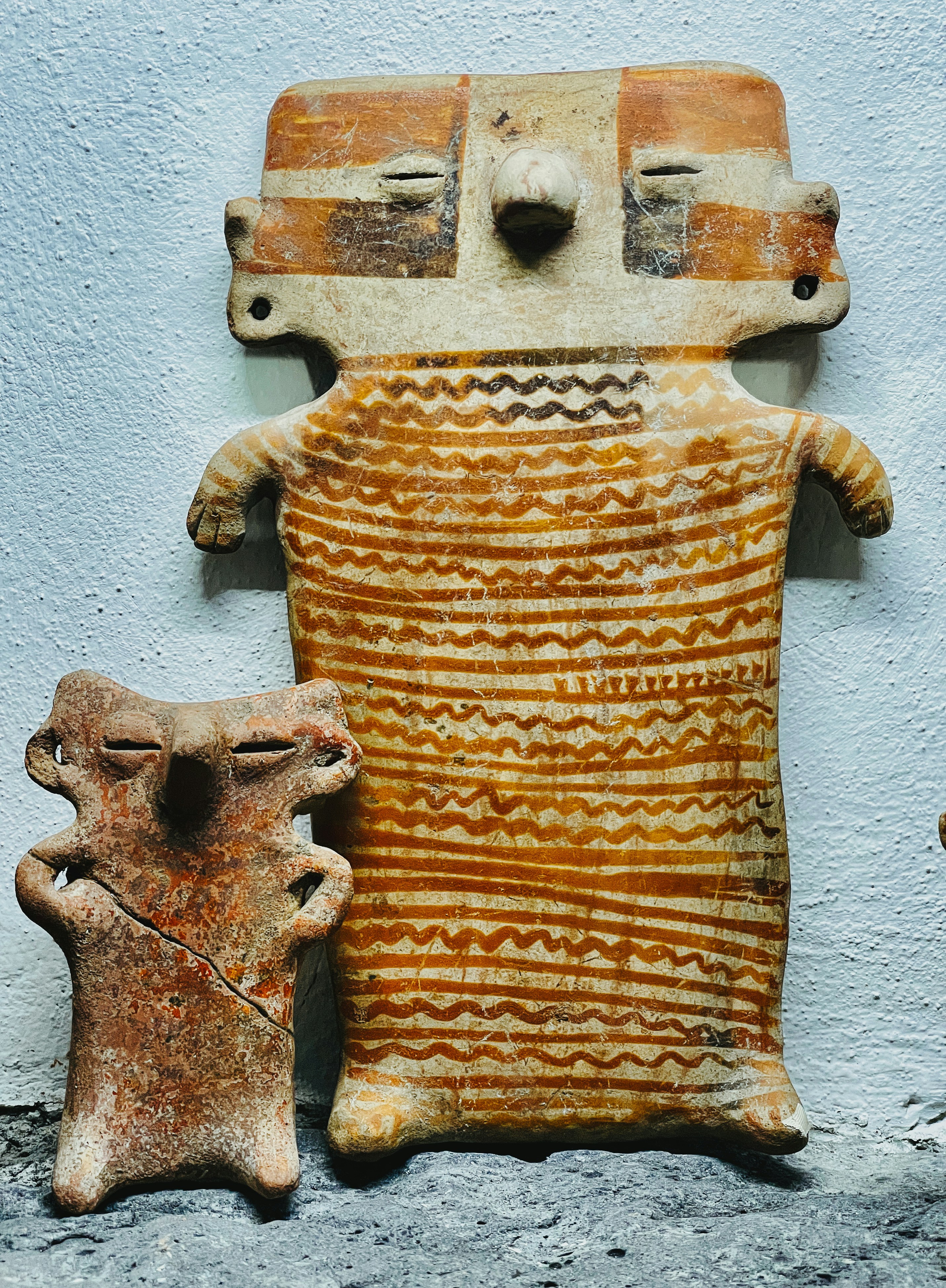 A stone statue of a man and a small statue of a dog