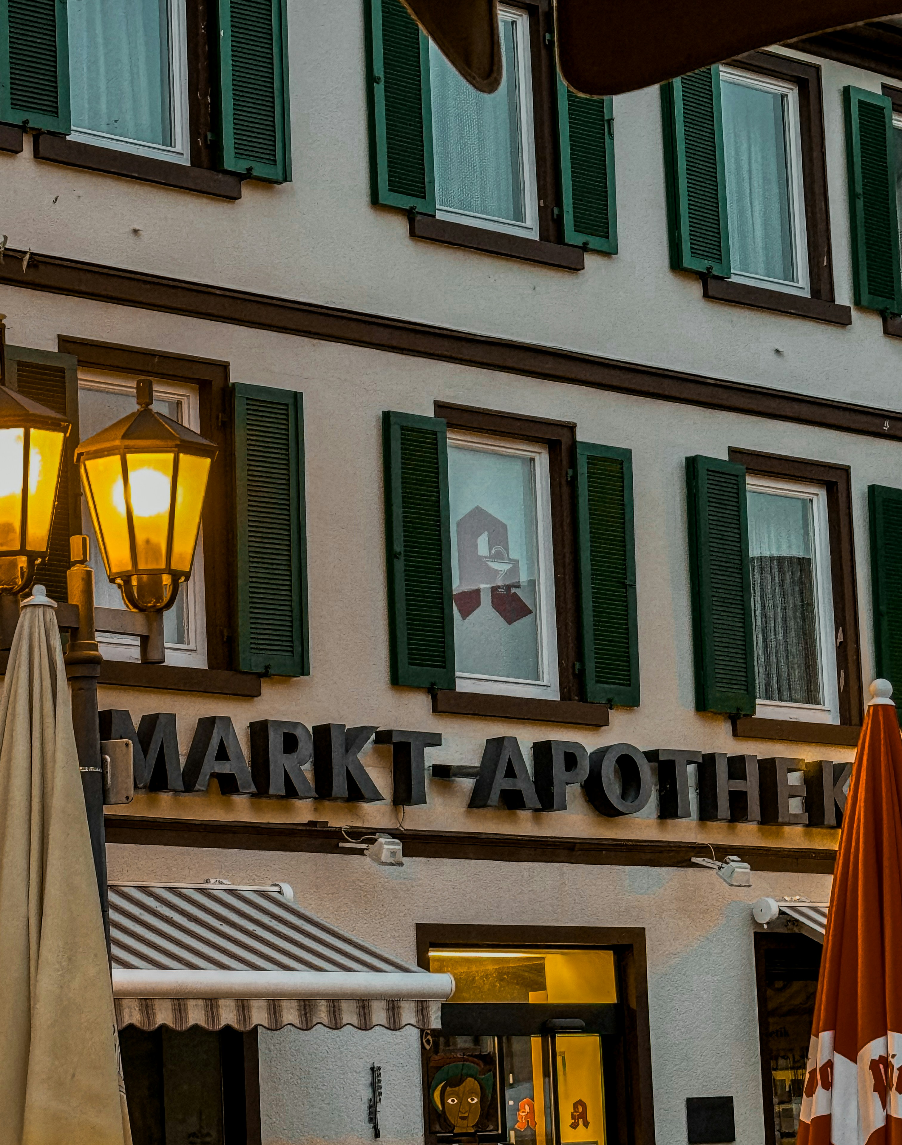 A building with green shutters and green shutters