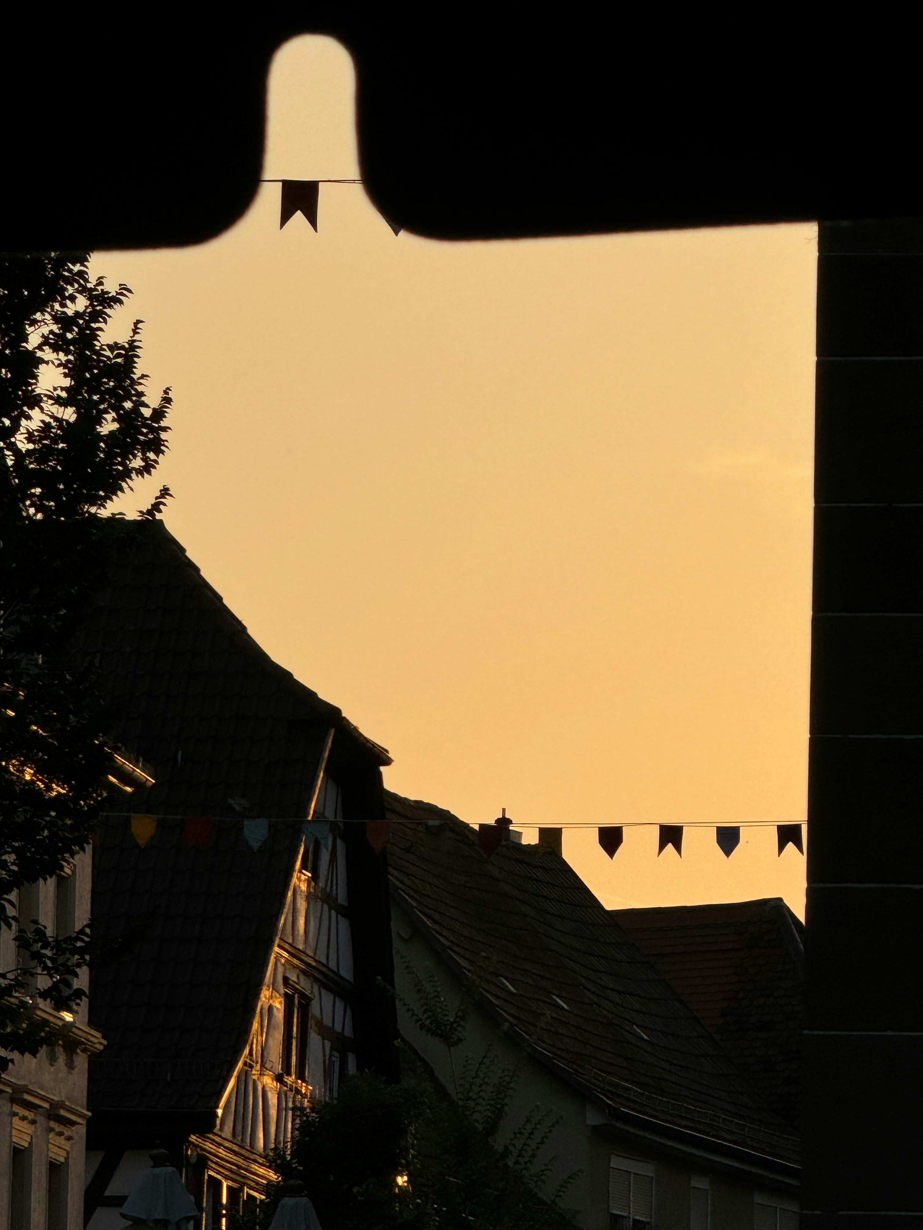 A plane is flying over a row of buildings