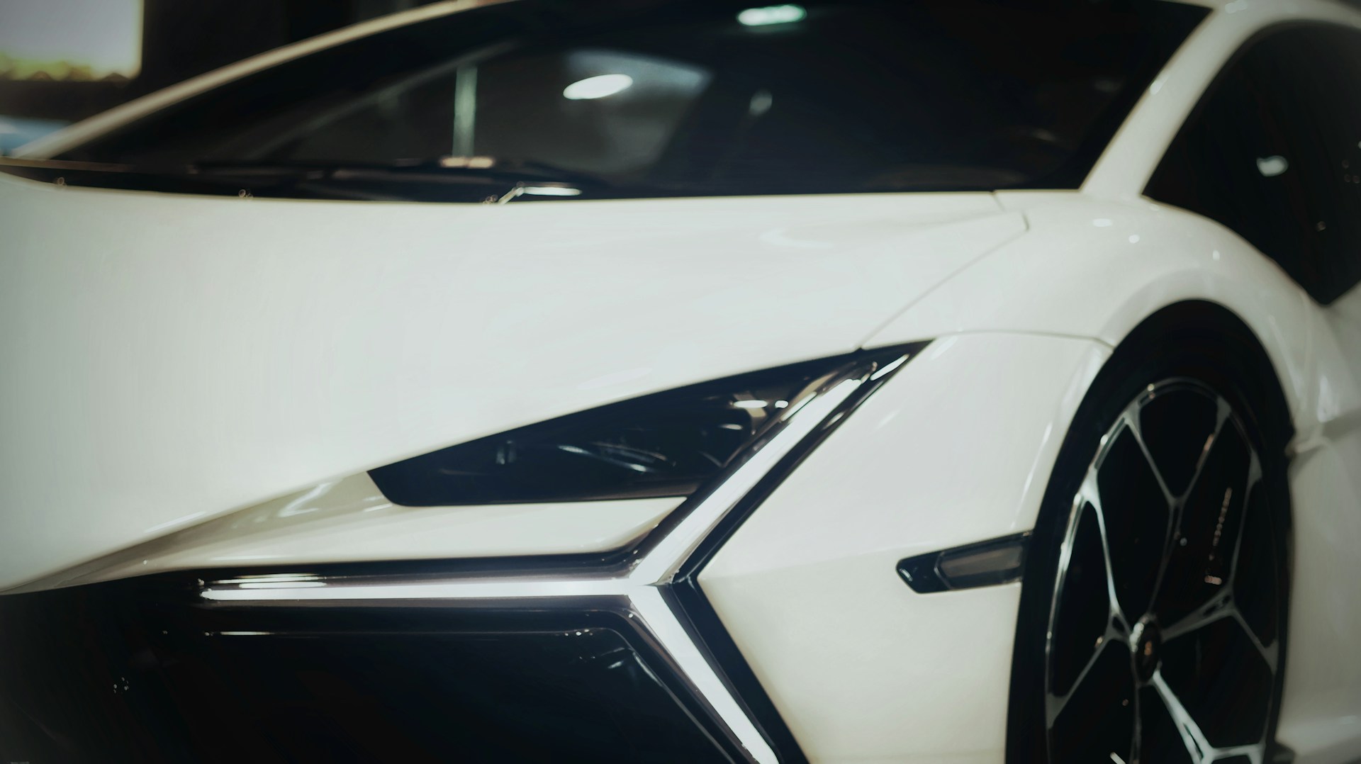 A white sports car parked in a garage