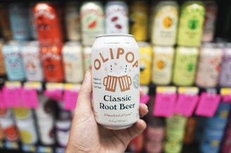 A person holding up a can of beer