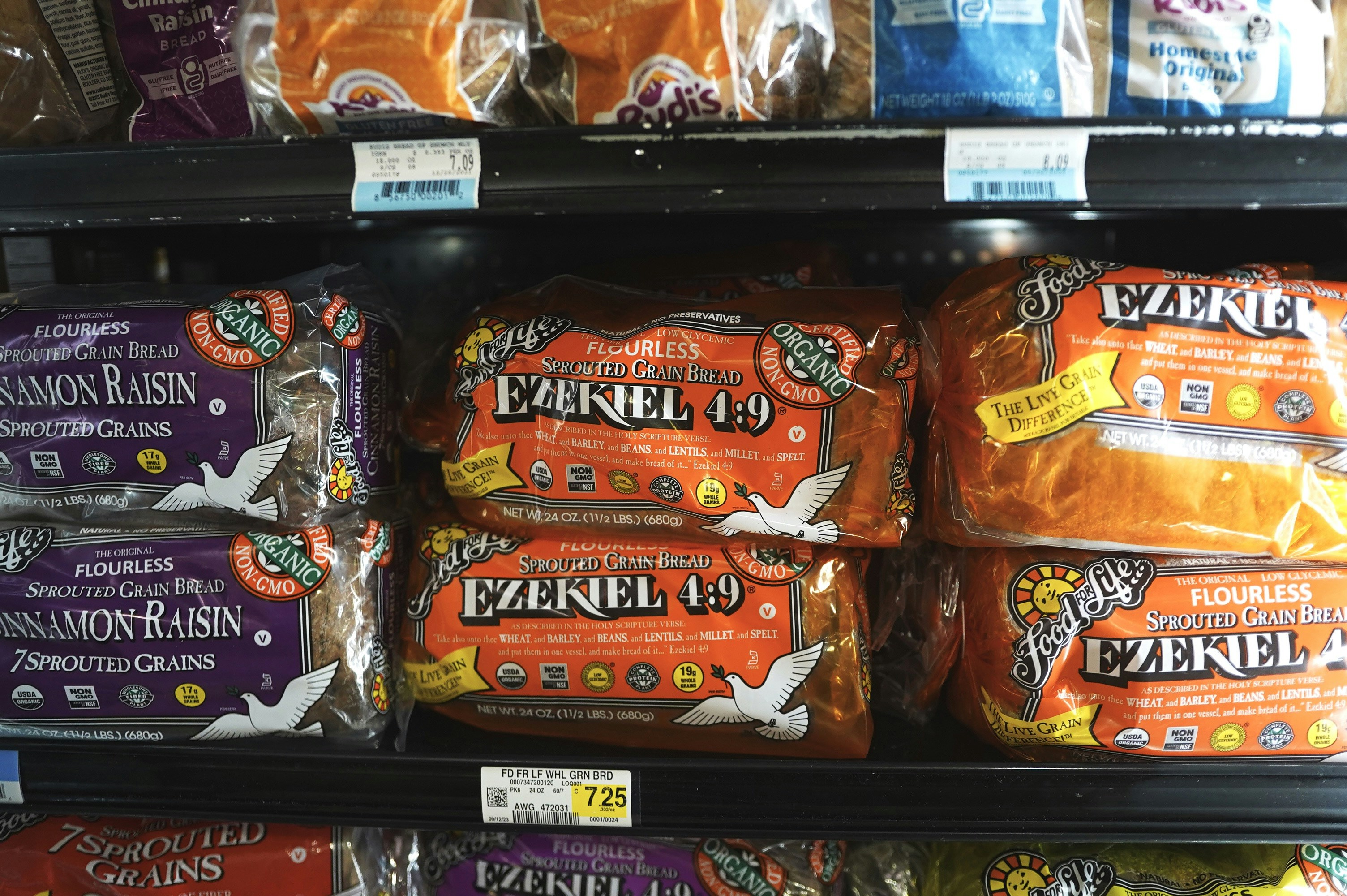 various pre-packaged nutritious snacks like nut bars, dried fruit, and seed crackers - healthy snacks to buy for work