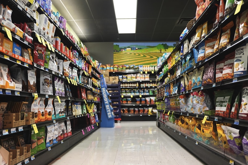 Retail aisle leading toward bright backlit signage