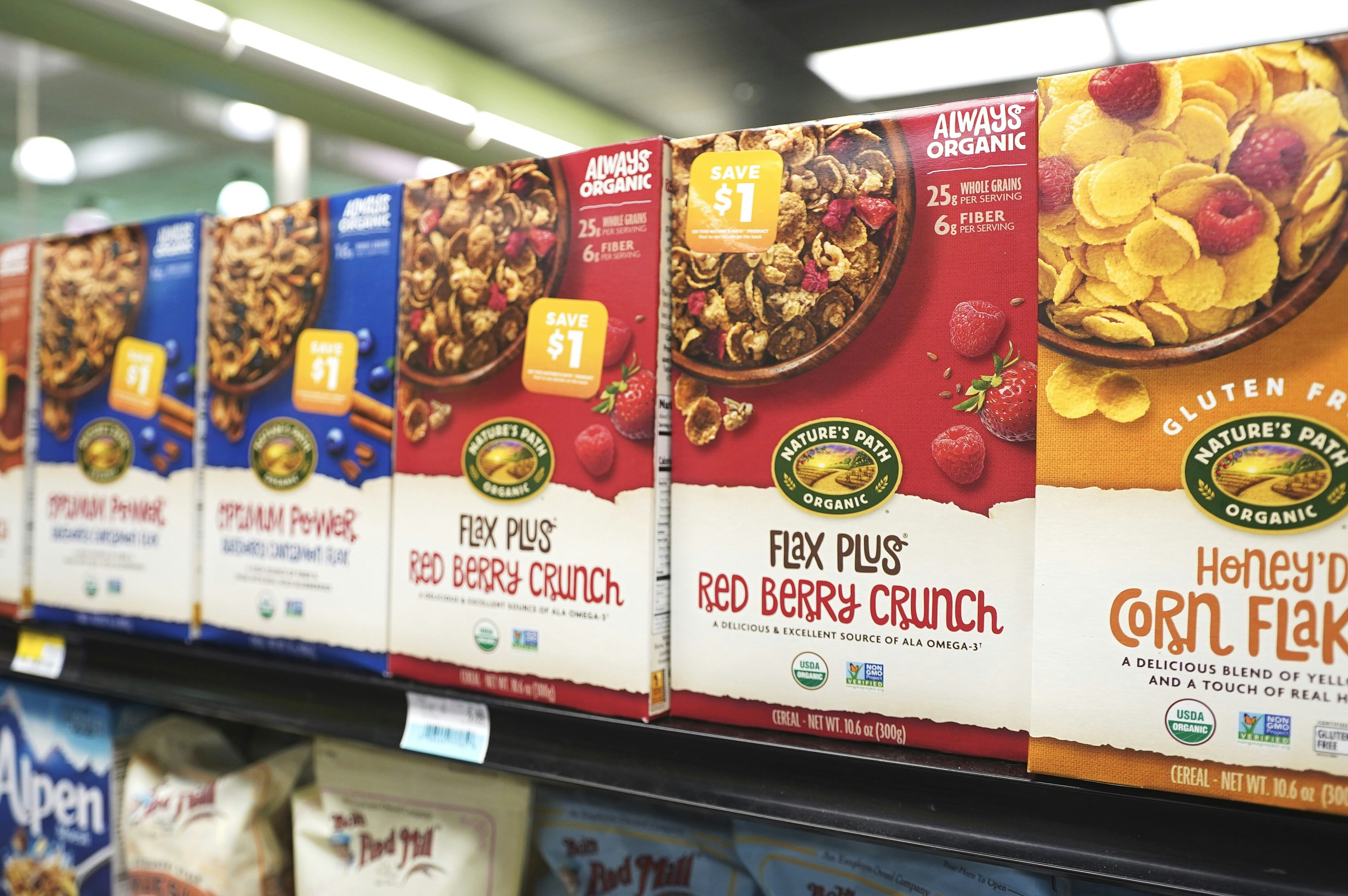 A store shelf filled with cereal and cereal