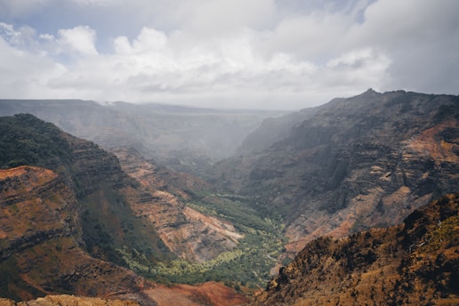 A scenic view of a valley with mountains in the background