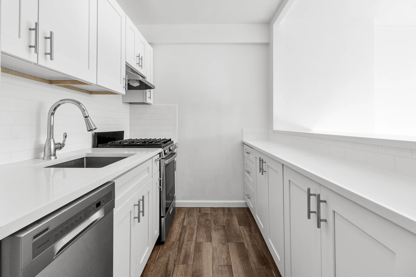 Bright white kitchen with wood floors