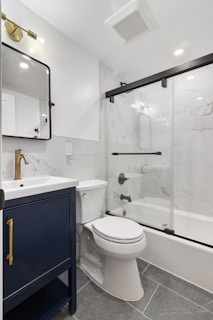 A bathroom with a toilet, sink, and shower
