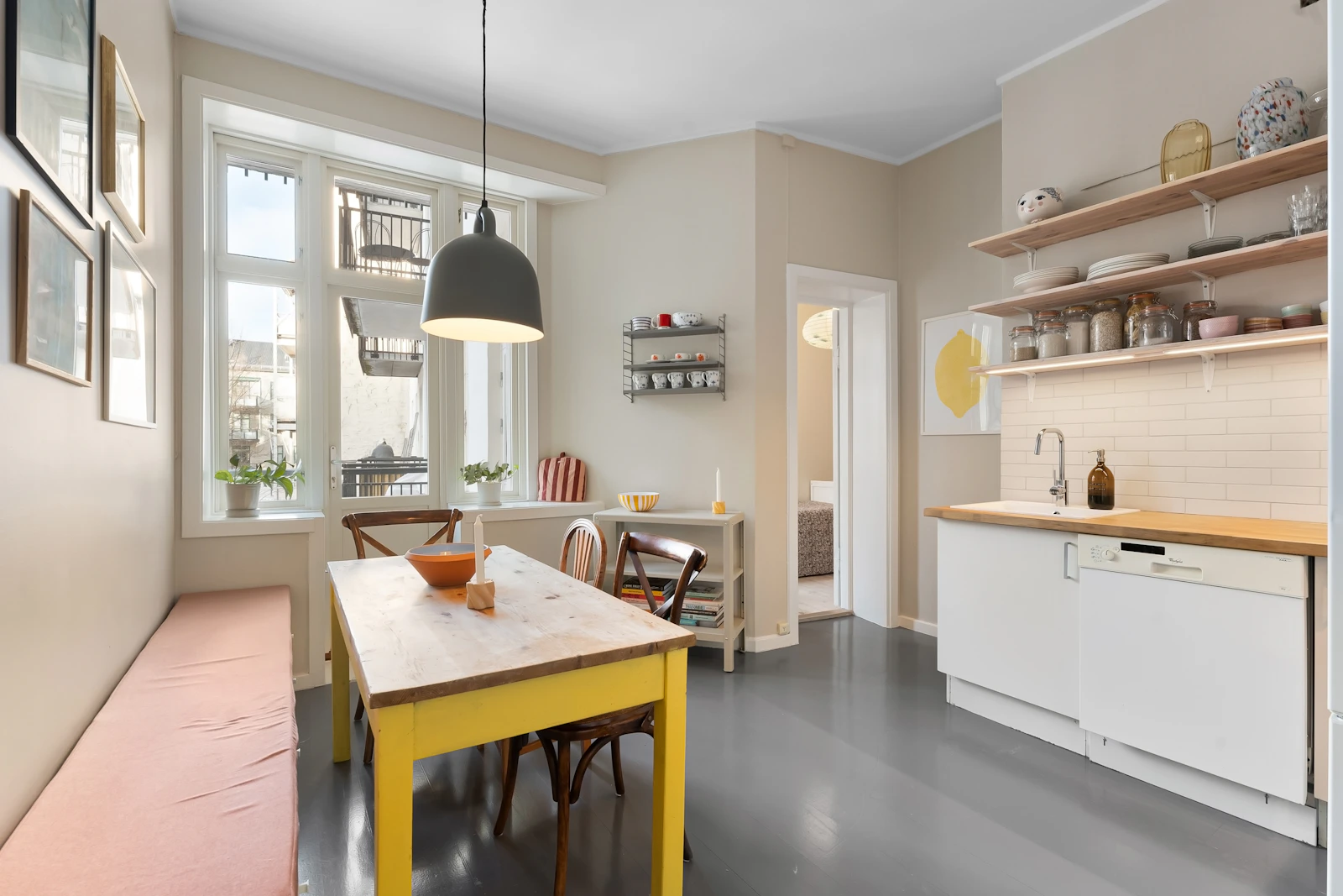 Bright dining and kitchen area using yellow as a warm focused accent