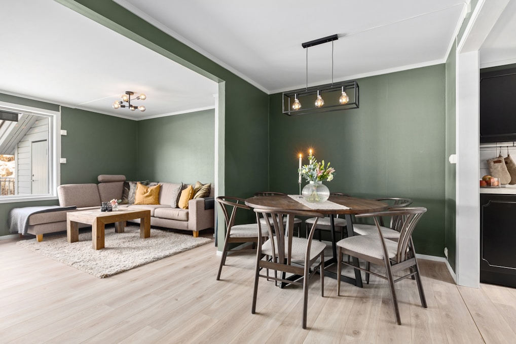 A living room filled with furniture and a dining table