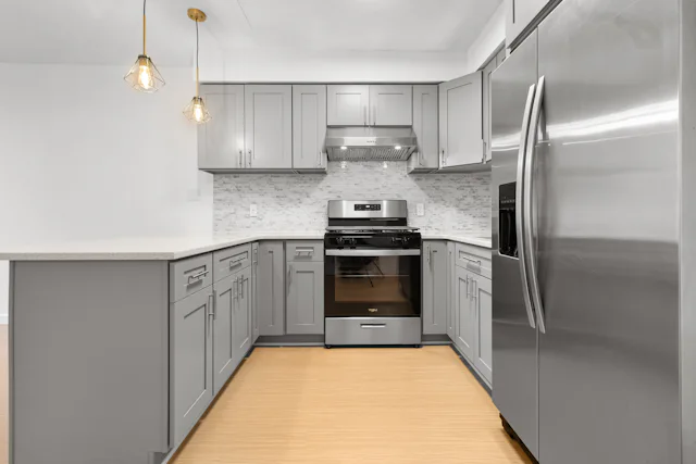 Upscale kitchen with stainless steel appliances similar to Sub-Zero units we repair in Somerville