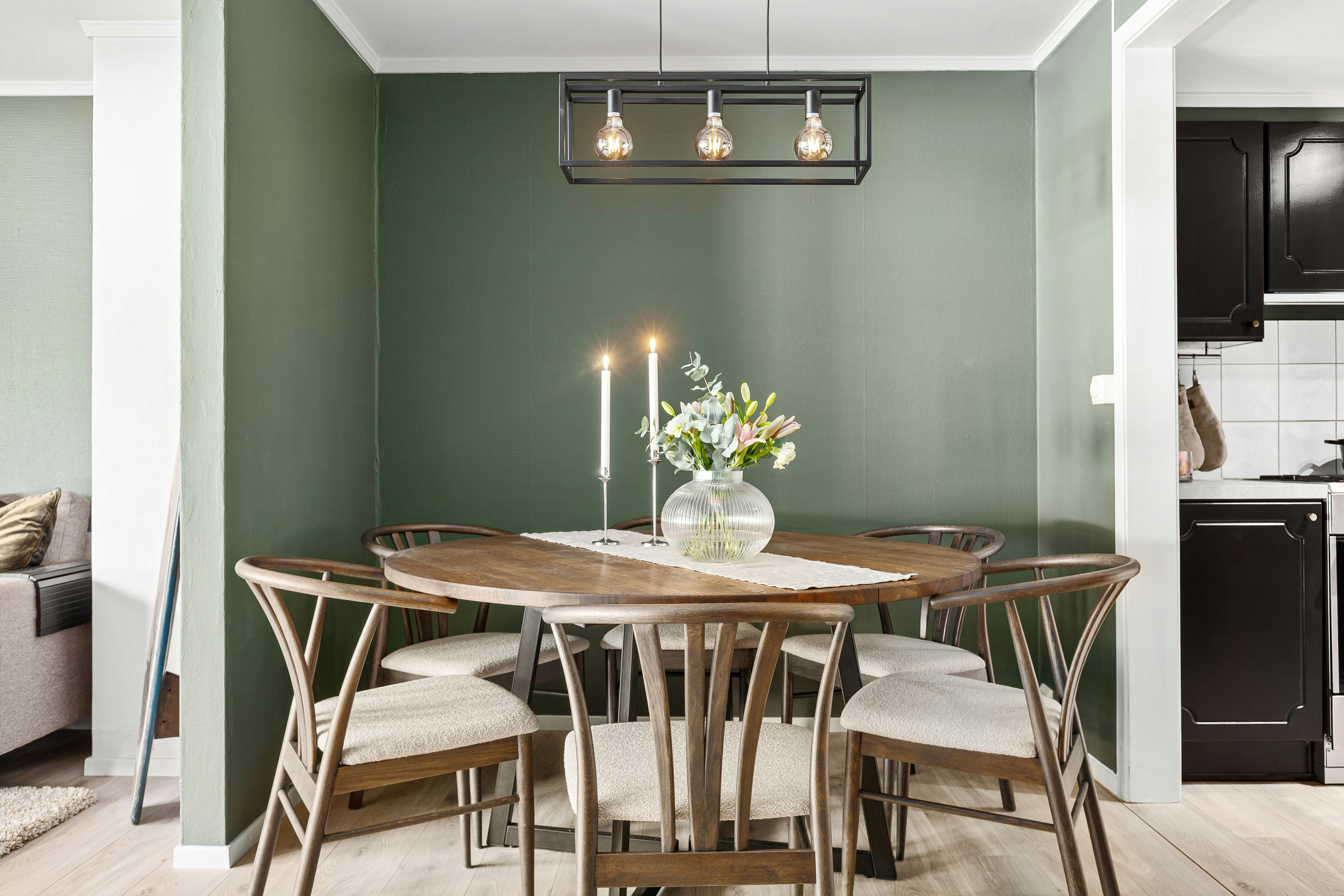 A dining room with a table and chairs