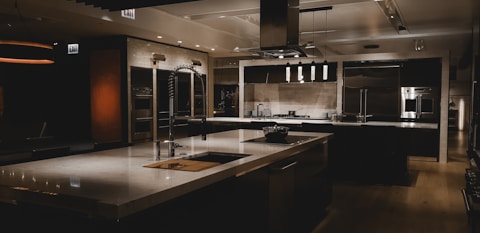 A large kitchen with a center island and stainless steel appliances