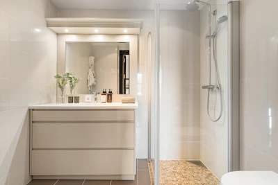 A bathroom with a tub, sink, and shower