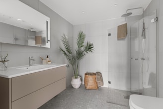 A bathroom with a large mirror and a sink