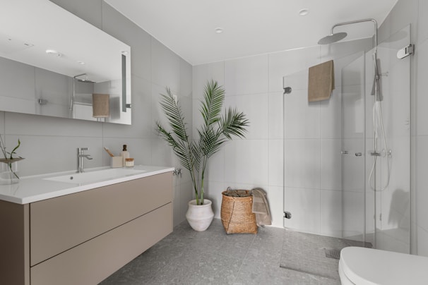 A bathroom with a large mirror and a sink