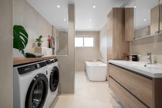 A bathroom with a washer and dryer in it