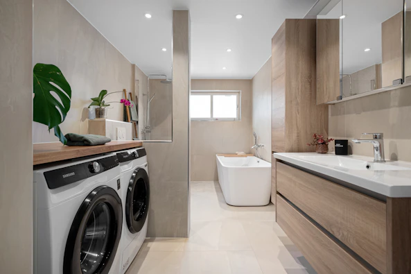 A bathroom with a washer and dryer in it