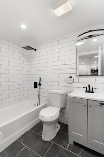 A bathroom with a toilet, sink, and bathtub