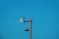 A street light with a blue sky in the background