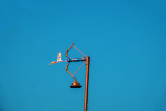 A street light with a blue sky in the background