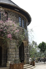 A stone building with a tree in front of it