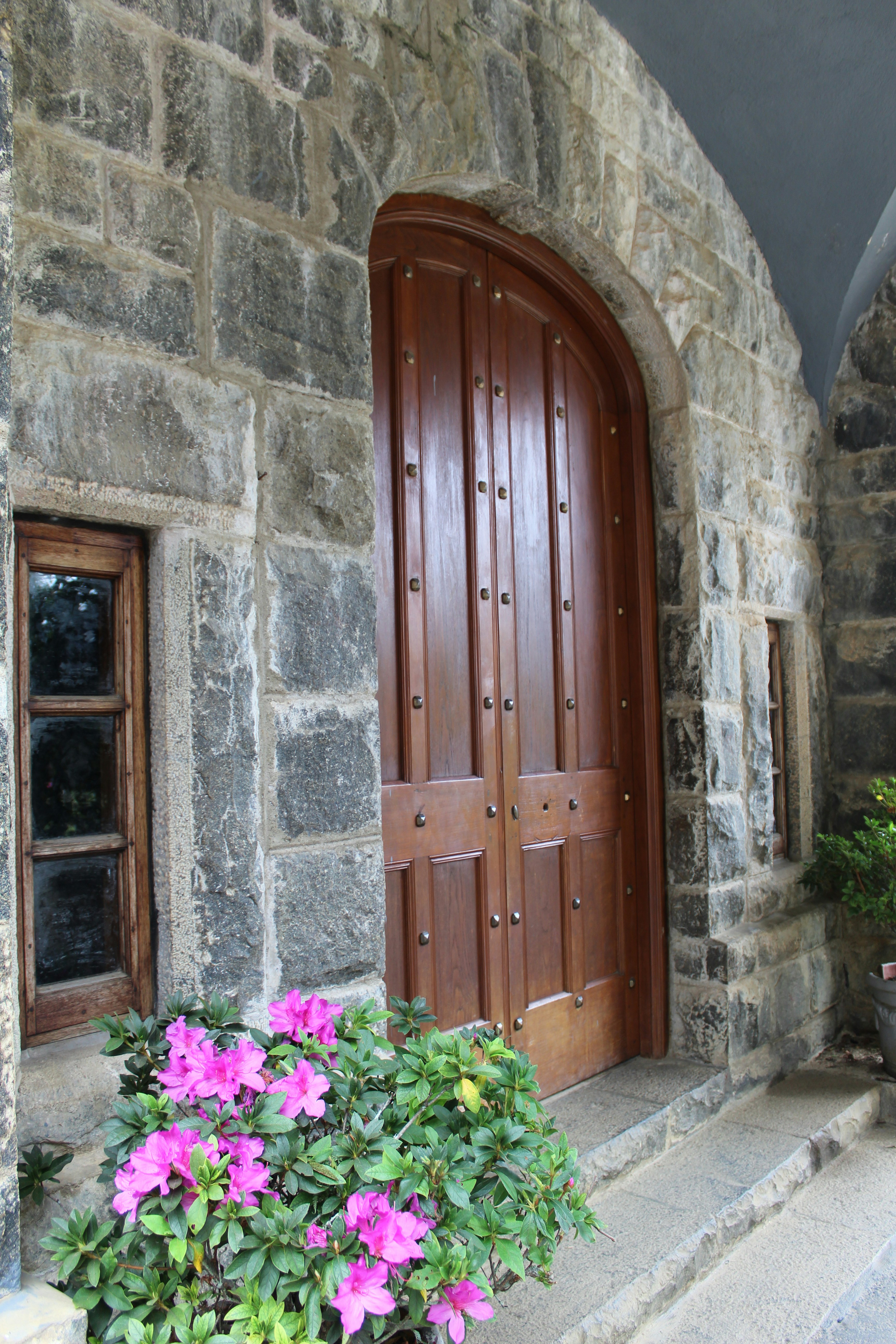 A stone building with a wooden door and window