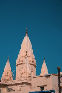 A tall white building with a clock on it's face