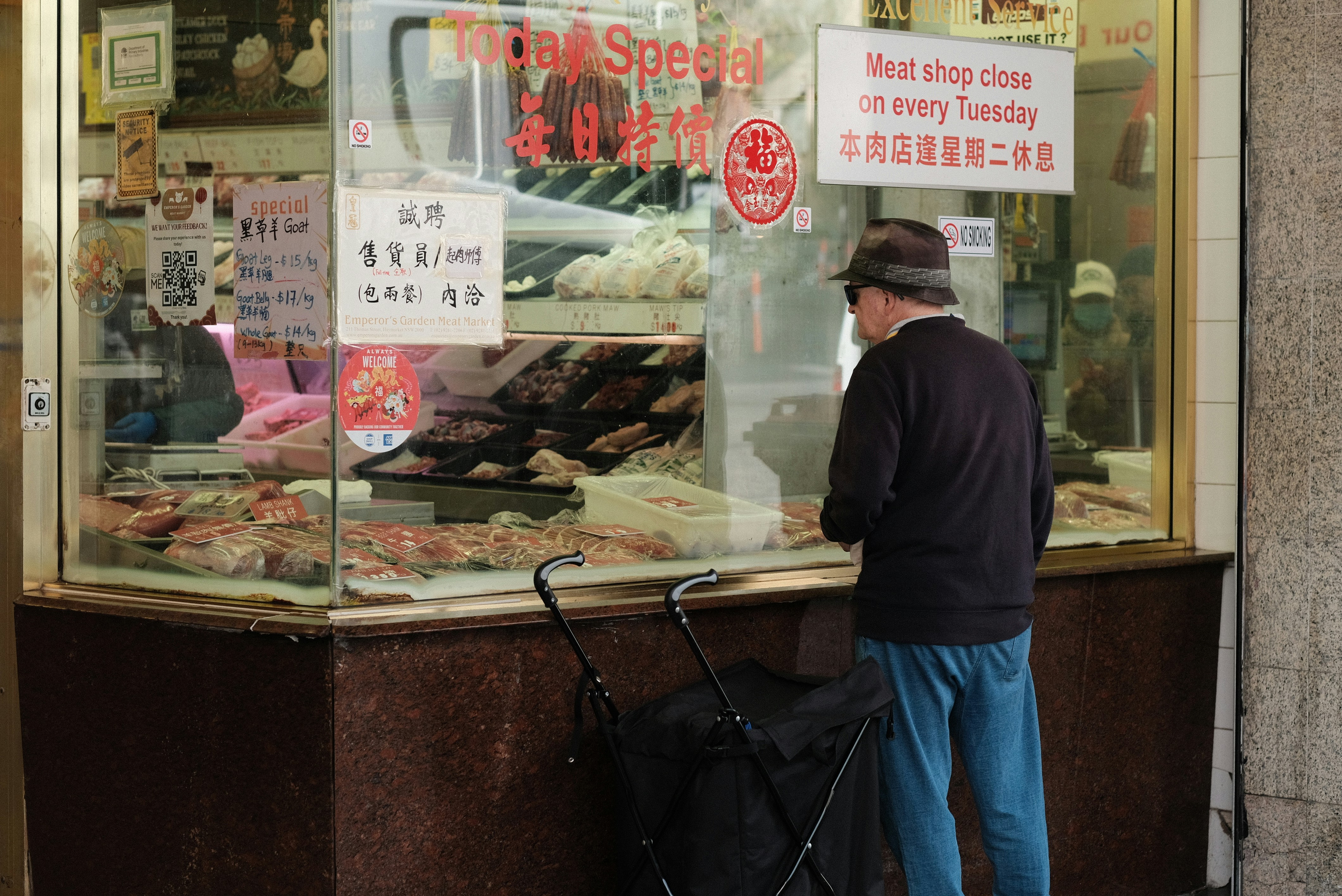 A man is standing outside of a bakery
