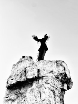 A person standing on top of a rock formation