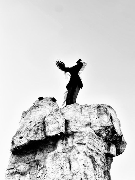 A person standing on top of a rock formation