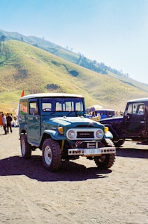 A group of jeeps parked on a dirt road