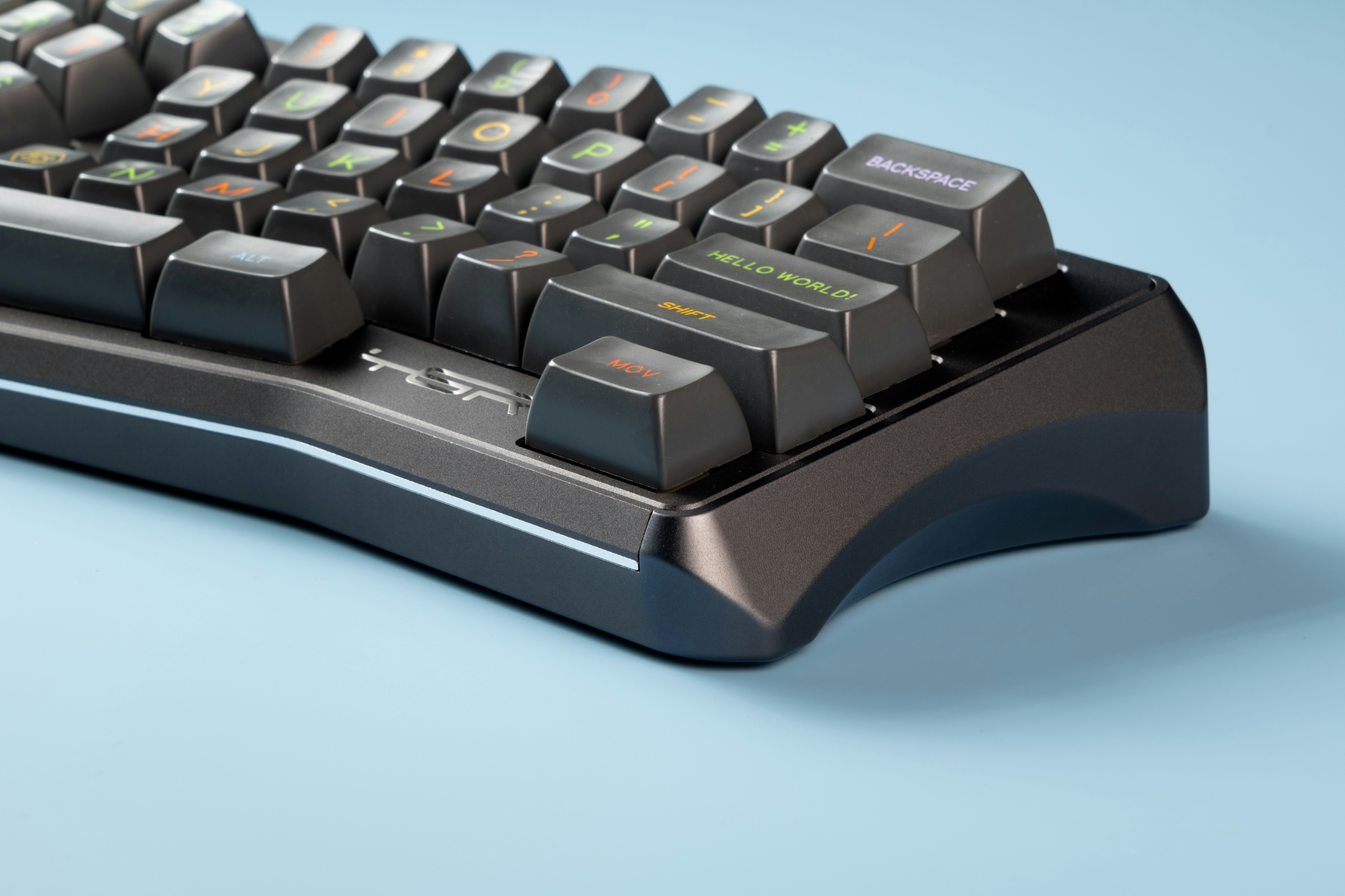 A computer keyboard sitting on top of a blue surface