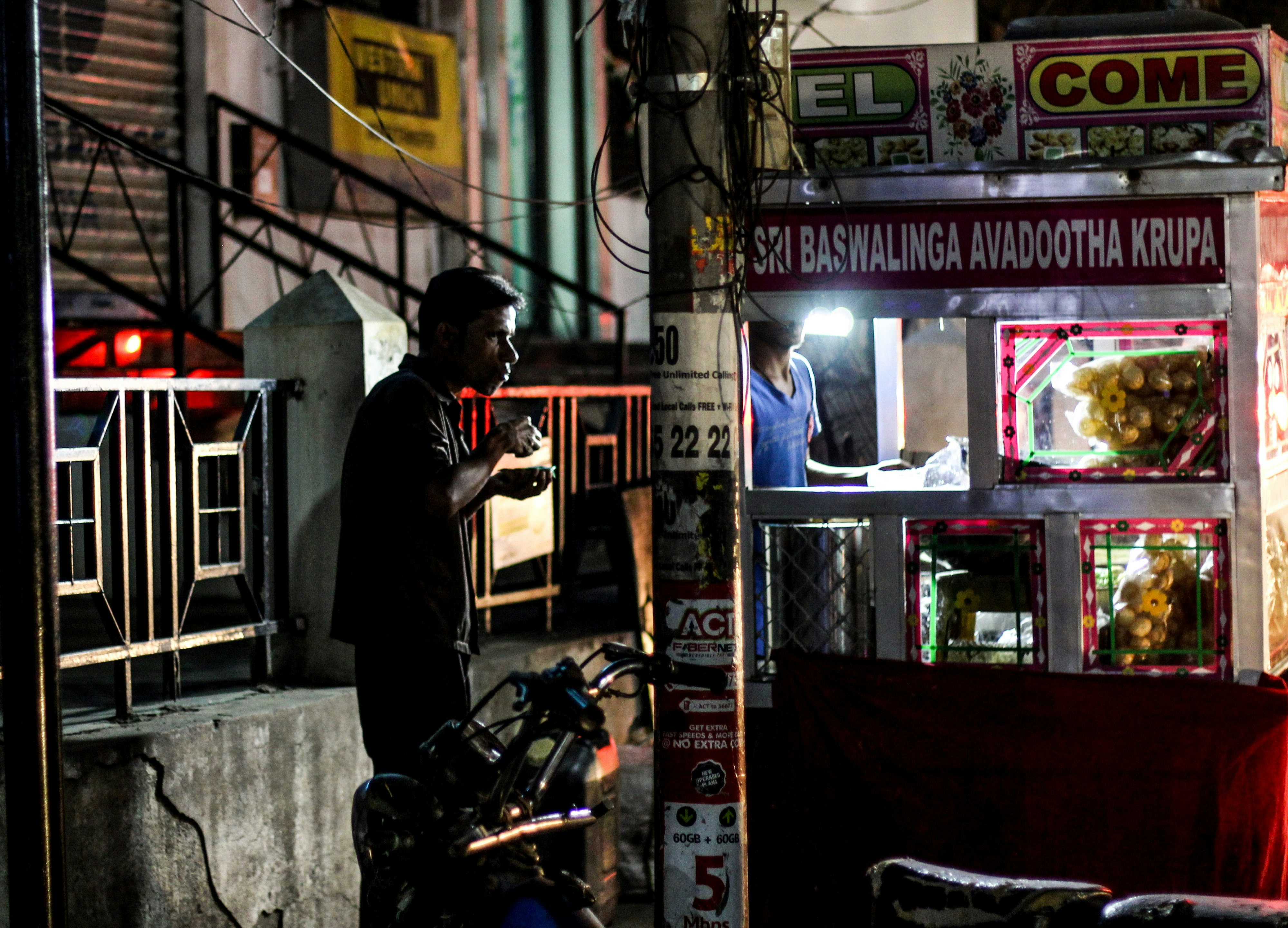 Man at night food stand