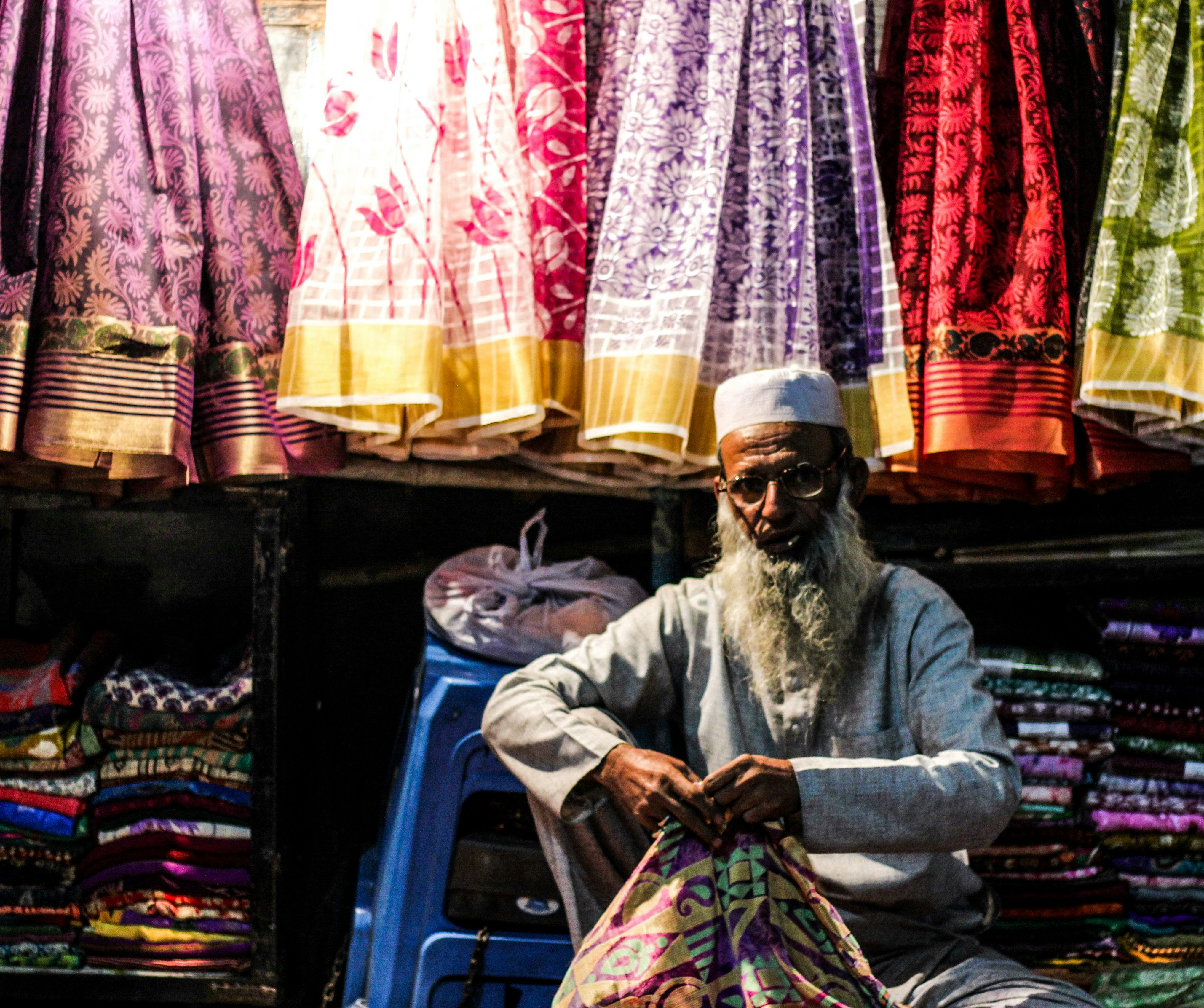A man sitting on a chair in front of a store