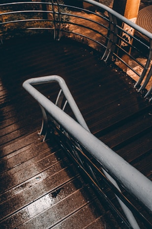 A metal hand rail on a wooden deck