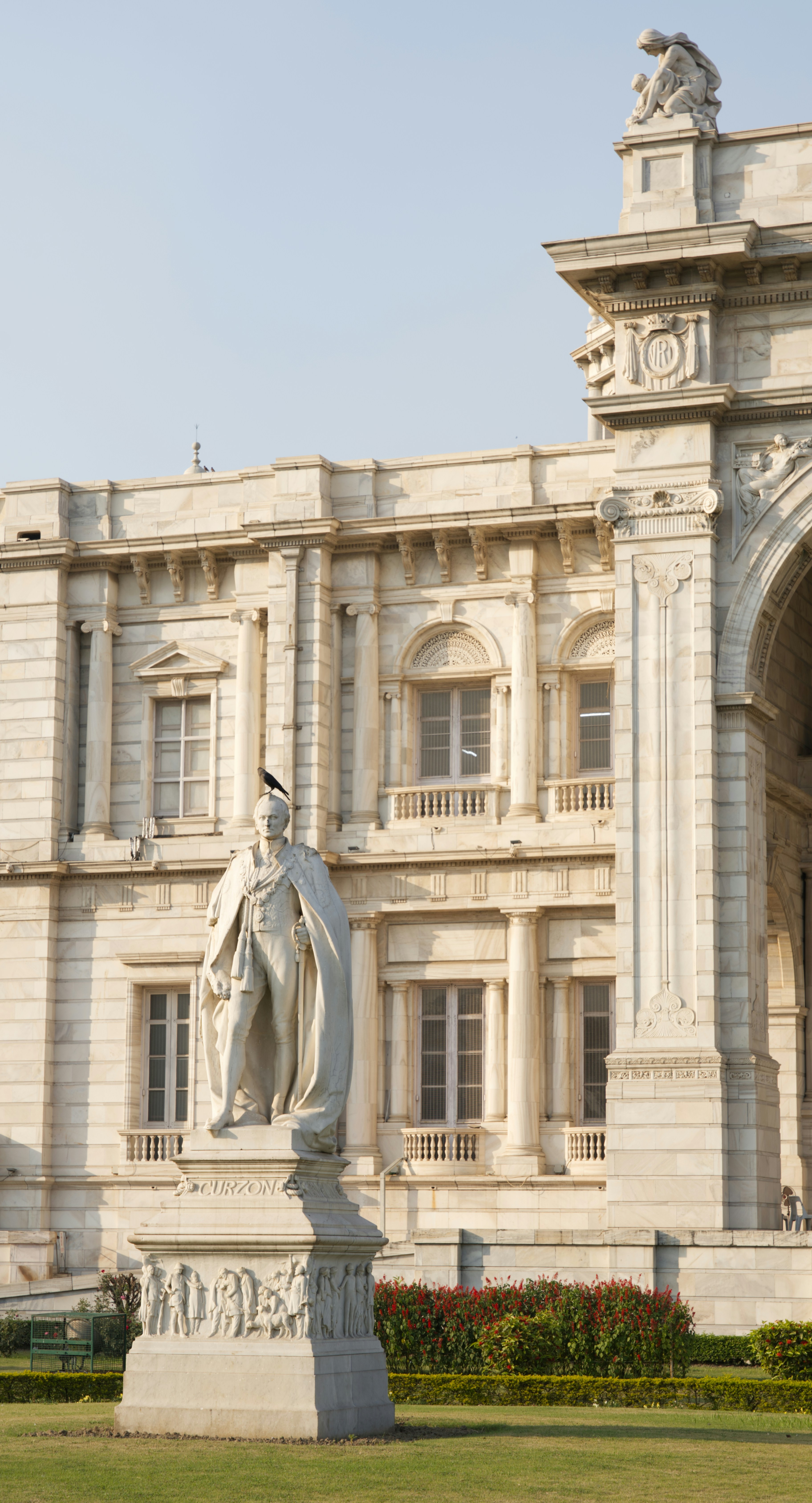A large building with a statue in front of it