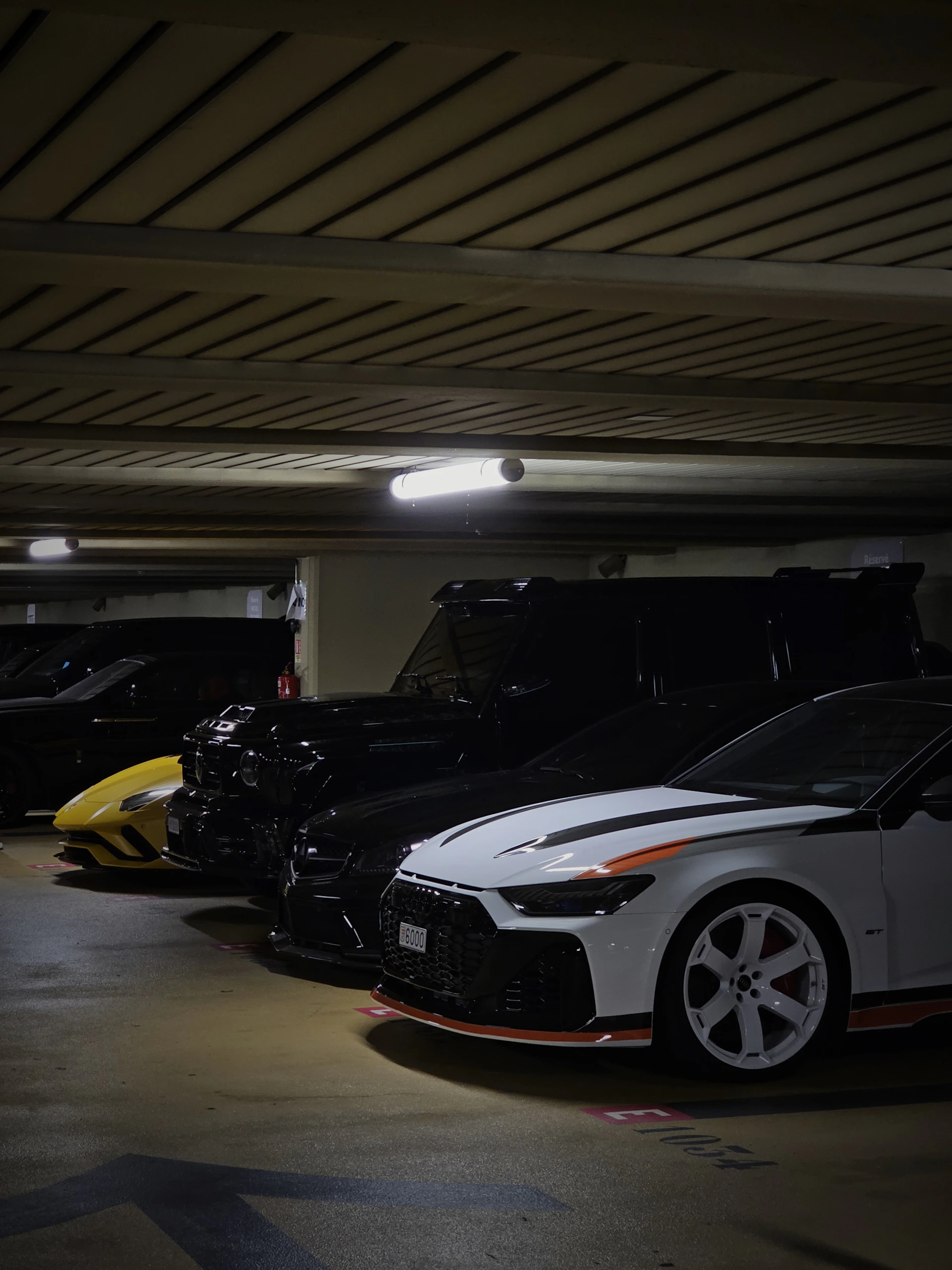 A group of cars parked in a parking garage