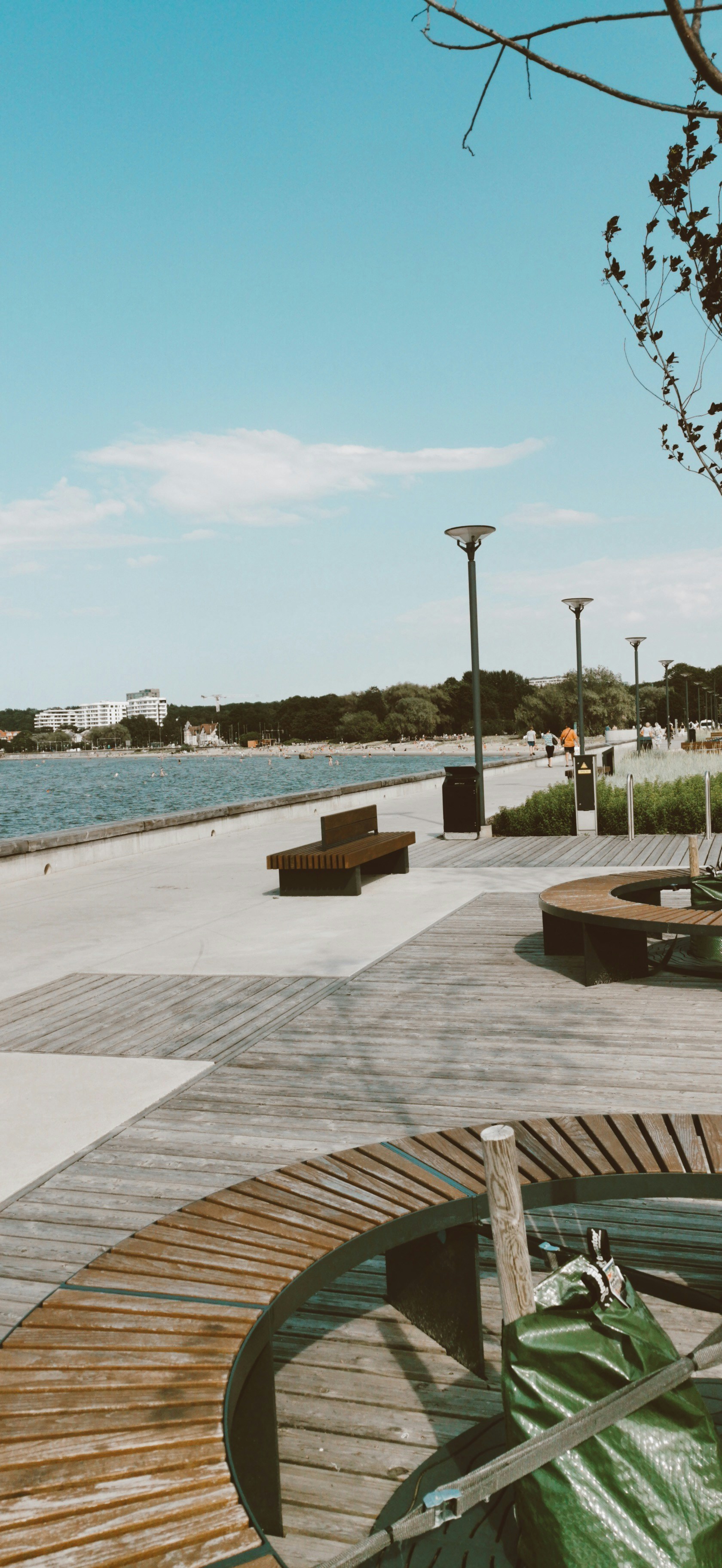 A wooden bench sitting next to a body of water