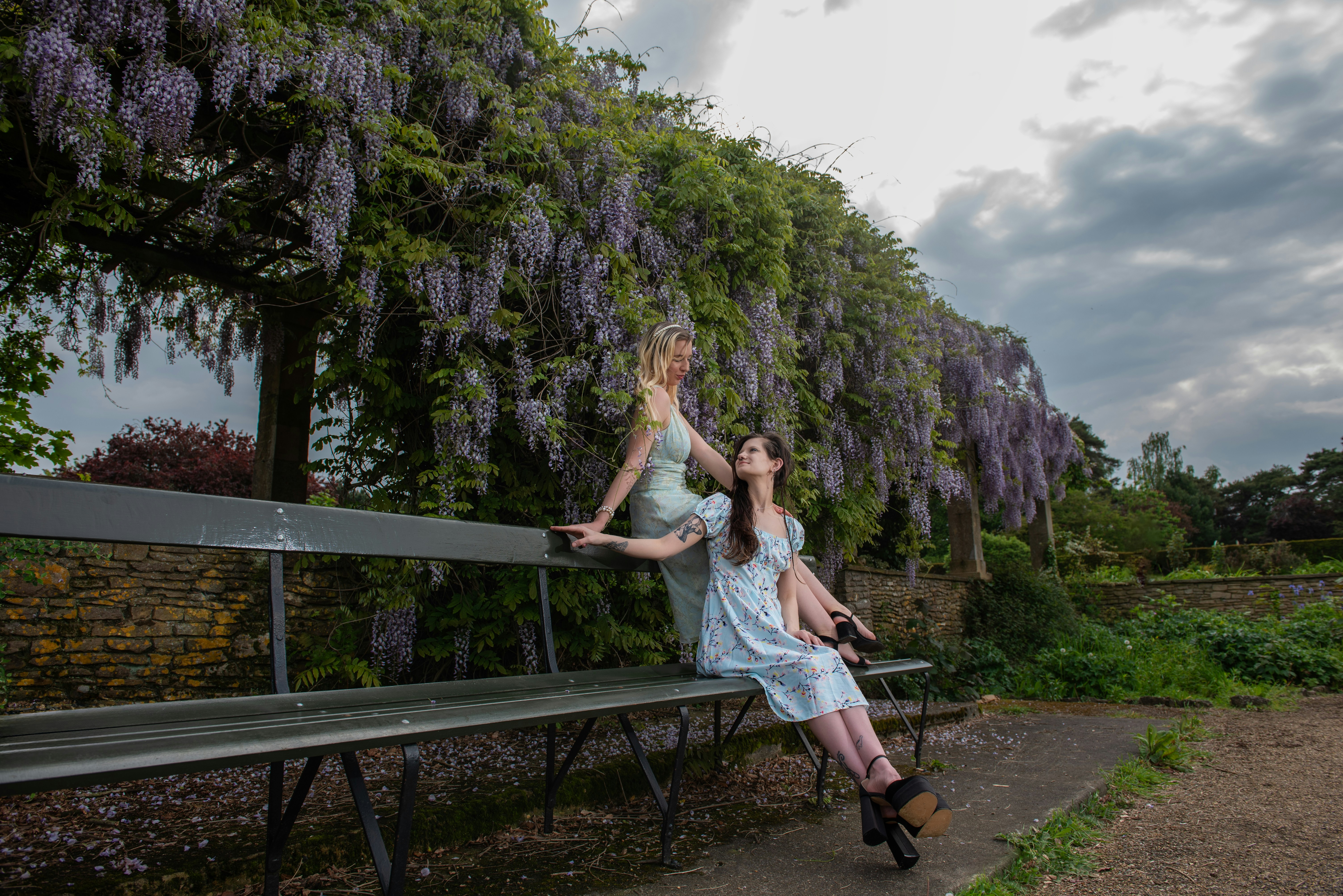 A woman sitting on a bench in a park