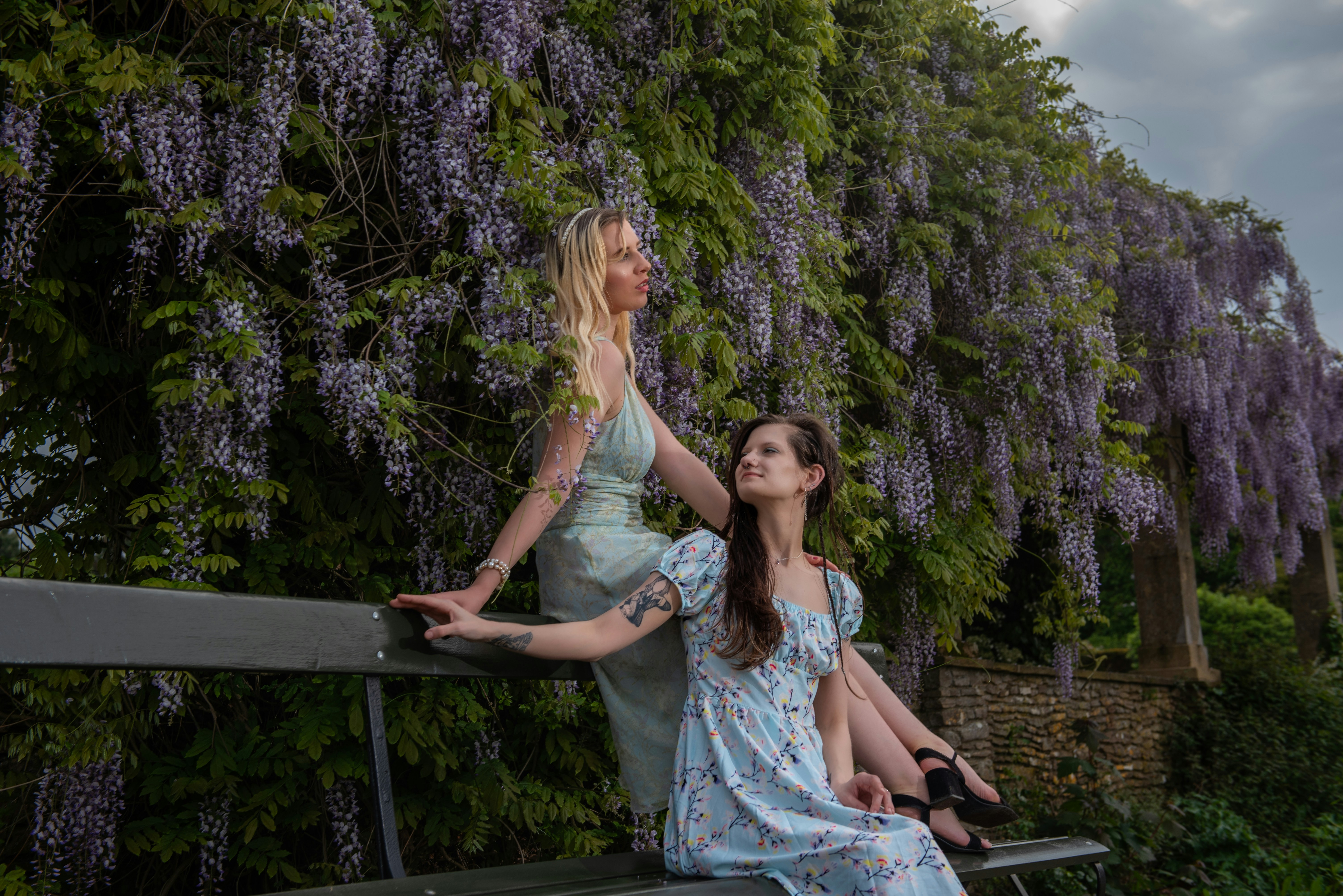 A couple of women sitting on top of a bench