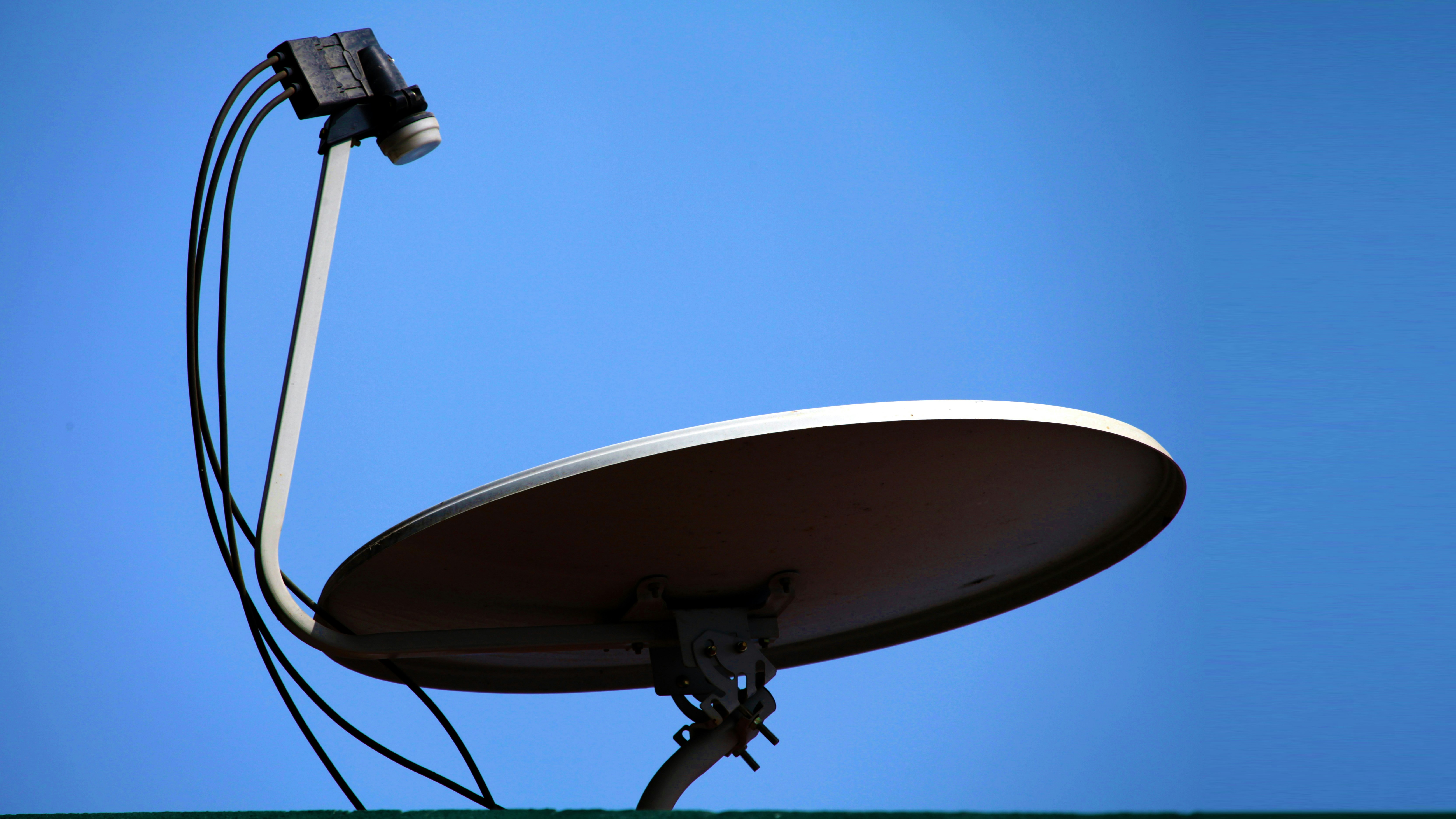 A satellite dish with a blue sky in the background