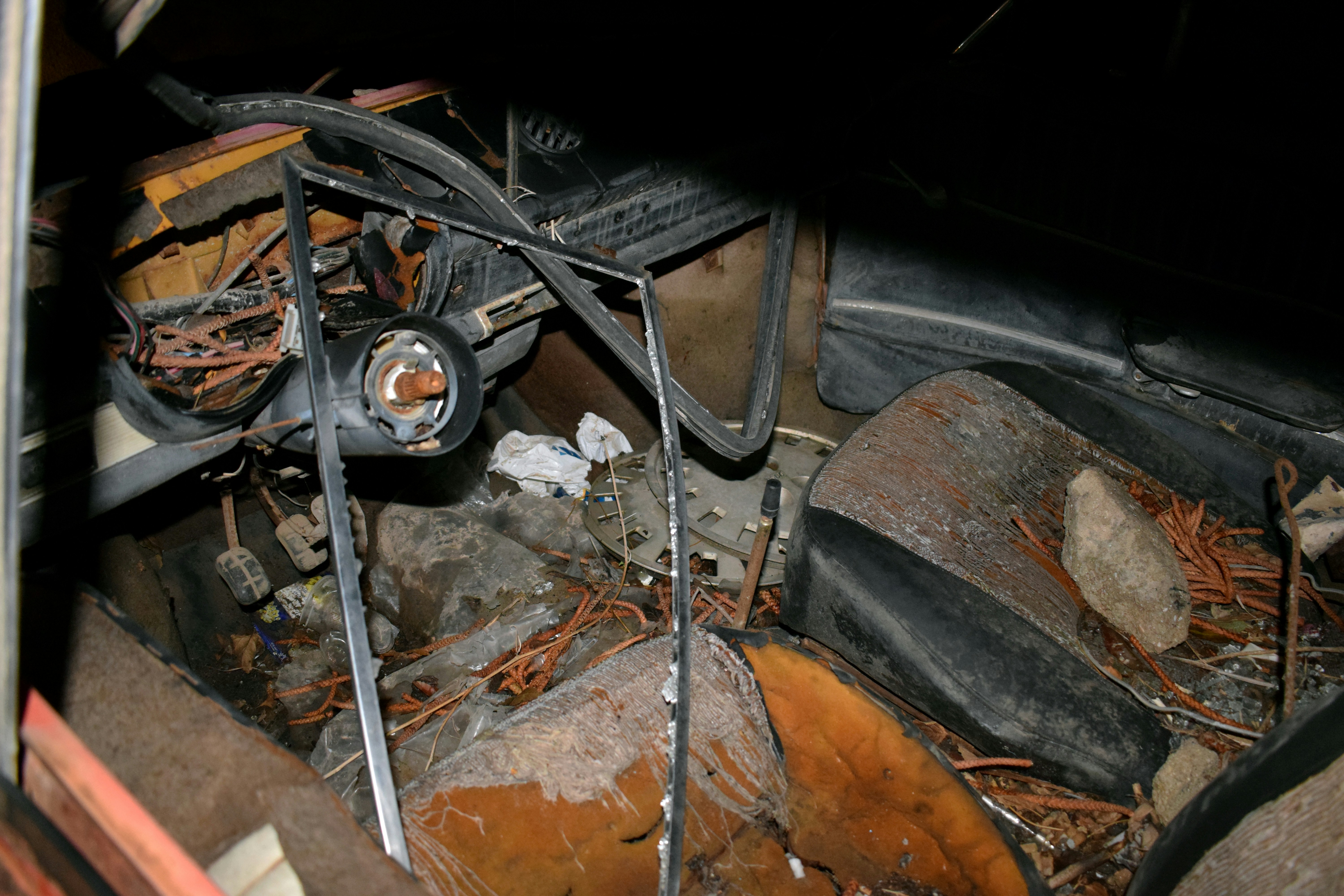 Technician inspecting disc brakes on an electric car with the wheel removed