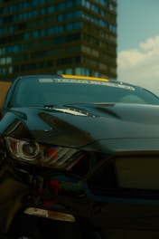 A black sports car parked in front of a tall building