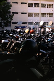 A large group of motorcycles parked in front of a building