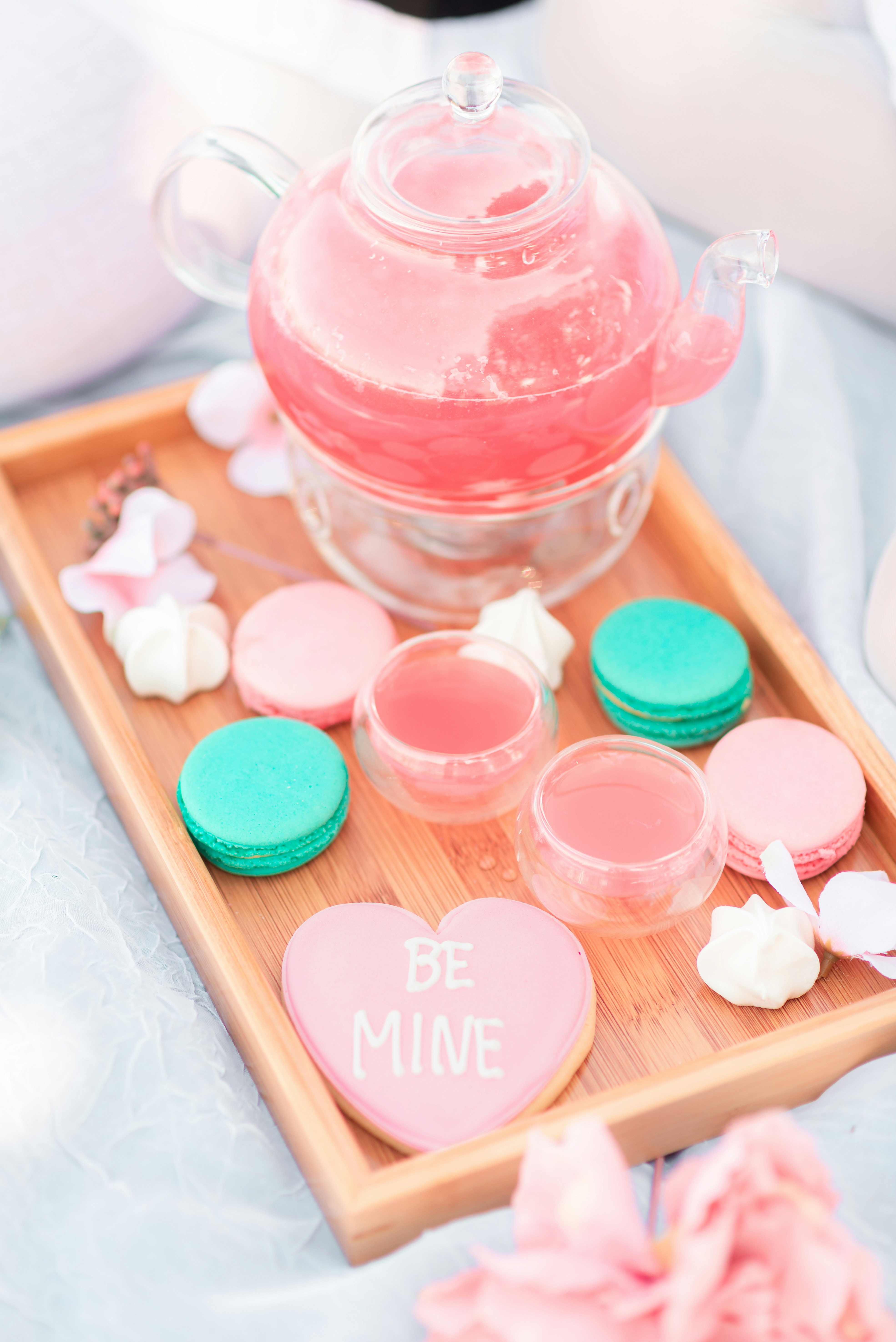A tray with cookies and a tea pot on it