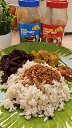 A plate with rice, sauces, and vegetables on it