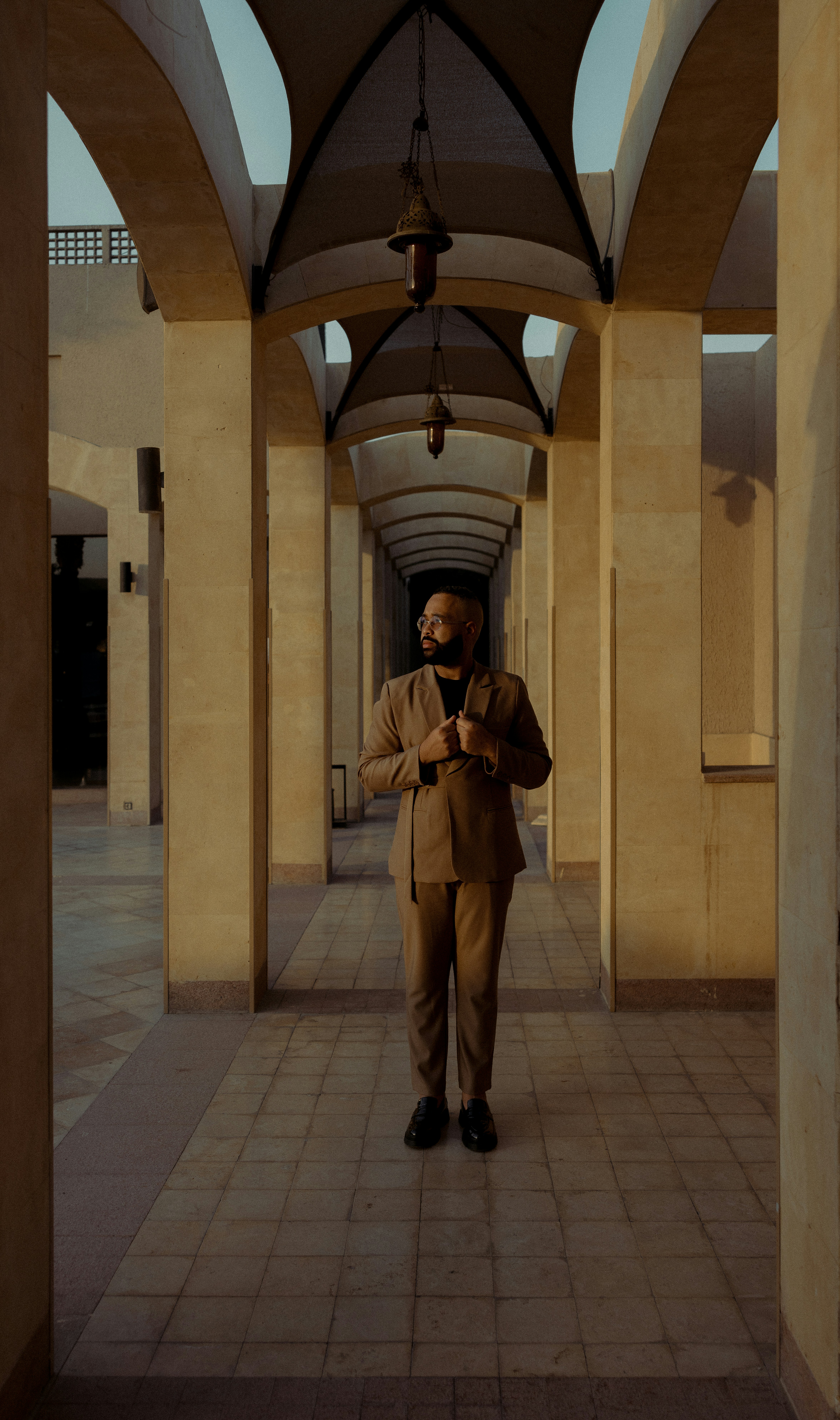 A man in a suit standing in a hallway