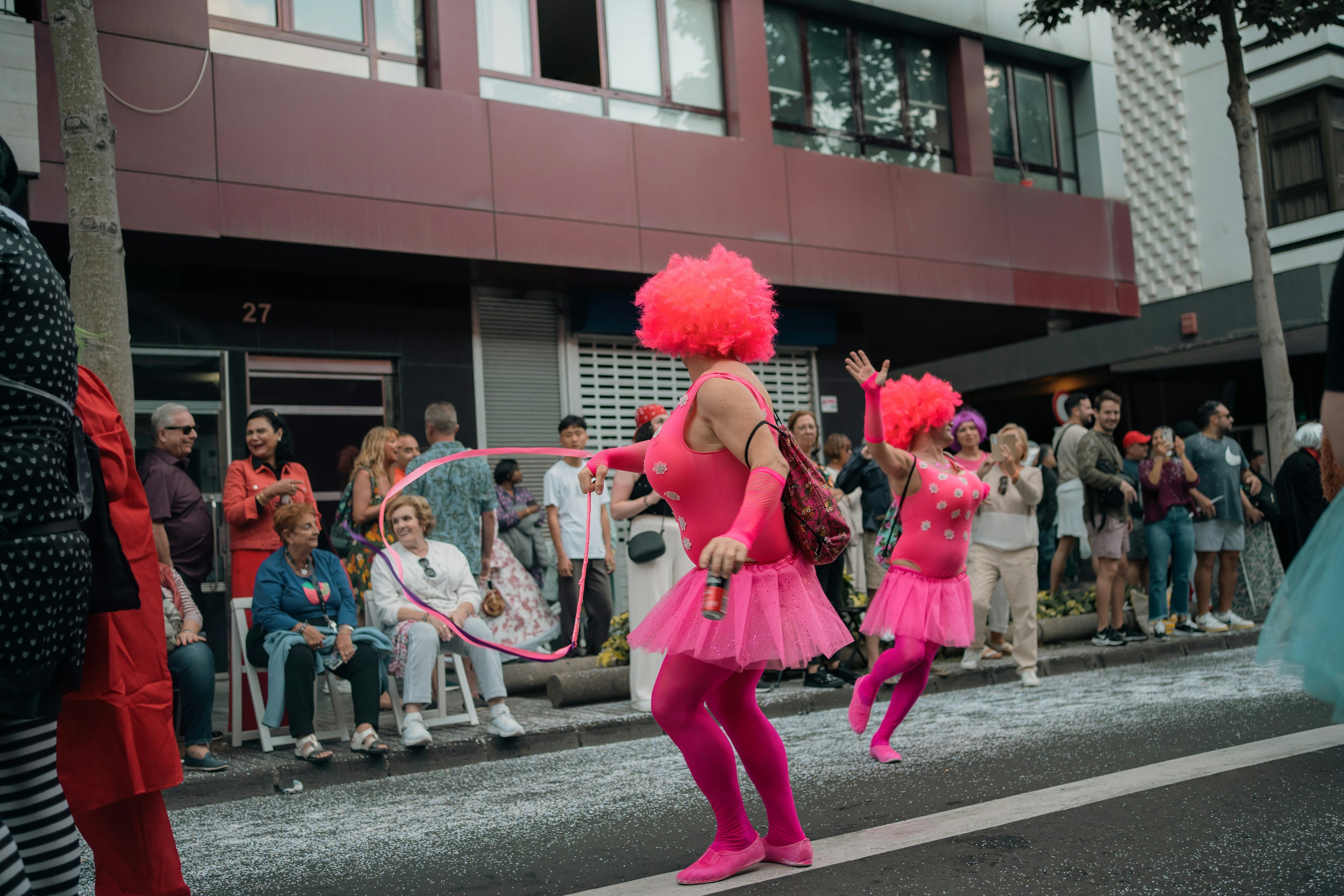A group of people standing on the side of a road