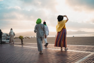 A couple of people that are walking down a street